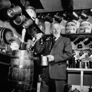 A man draws a pint from a barrel